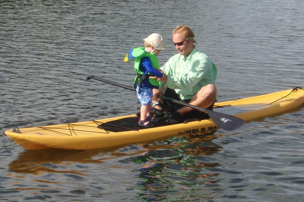 Father and child together on a stand up paddleboard during their family outing