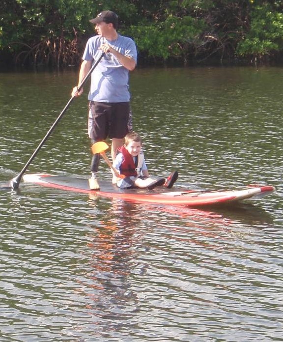 Sean Fitzgibbon and his son on a stand up paddleboard during a family outing in August 2010